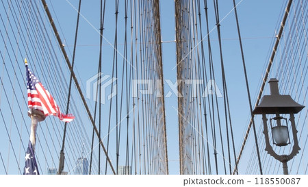 American flag on Brooklyn Bridge to Manhattan, New York City. Patriotic symbol. Travel USA. American flag on Brooklyn Bridge to Manhattan, New York City. Patriotic symbol. Travel USA. 118550087