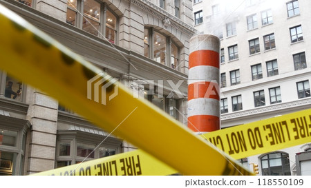 Steam vapor vented, New York City street steam system, orange vapour tube stack. Hot smoke from pipe 118550109