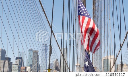American flag on Brooklyn Bridge to Manhattan, New York City. Patriotic symbol. Travel USA. American flag on Brooklyn Bridge to Manhattan, New York City. Patriotic symbol. Travel USA. 118550117