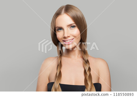 Positive young healthy woman with pigtail hairstyle and natural make-up on white background Positive young healthy woman with pigtail hairstyle and natural make-up on white background 118550893