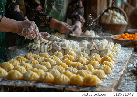A group of friends making dumplings for Lunar New Year. 118551348
