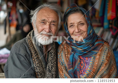 Elderly couple in traditional attire sitting together 118551953