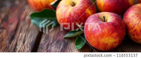 Red apples green leaves rustic wooden table natural autumn harvest horizontal copy space 118553137