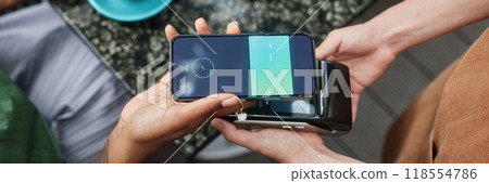 Website banner of woman paying via smartphone in local cafe 118554786