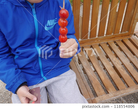 Child eating strawberry candy (no face) 118554806