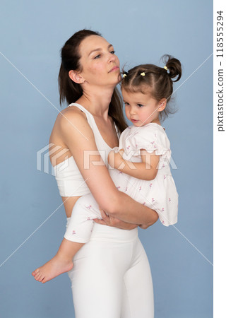 Woman slouches when holding child Woman slouches when holding child 118555294