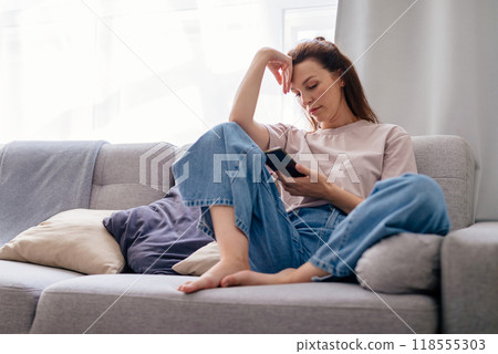 Young female chatting in social network or surfing internet, shopping online. Young female chatting in social network or surfing internet, shopping online. 118555303