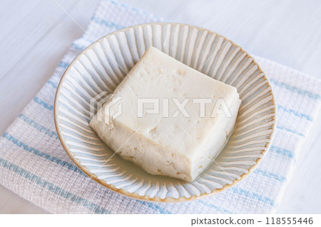 Firm tofu that has had its water removed by heating in the microwave Firm tofu that has had its water removed by heating in the microwave 118555446