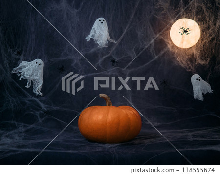 Halloween night background with pumpkin, ghosts, cobwebs and glowing moon. Creative DIY Halloween decor. Halloween greeting card. 118555674