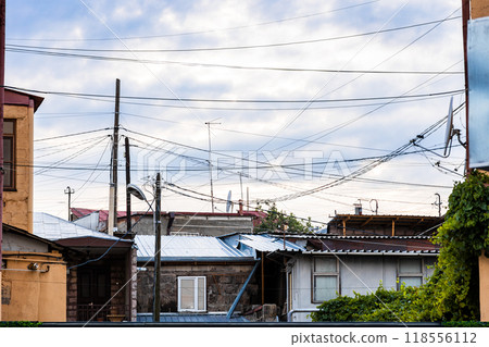 many electrical wires over urban houses many electrical wires over urban houses 118556112