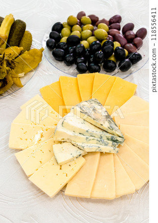 snacks, sliced armenian cheeses and olives closeup snacks, sliced armenian cheeses and olives closeup 118556411