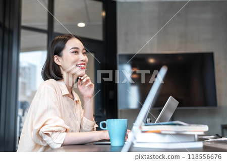 Woman laughing during work break Woman laughing during work break 118556676