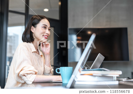 A woman smiling during a break from work A woman smiling during a break from work 118556678