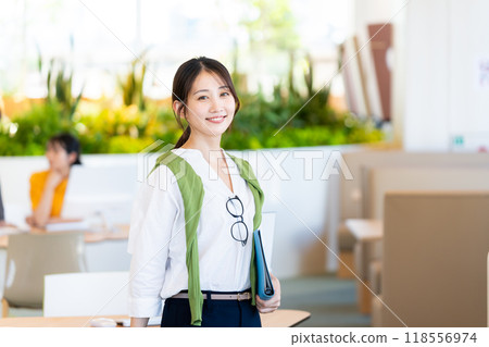 Businesswomen working in an office. Photo courtesy of Denpa Gakuen, Tokyo Electronics College. 118556974