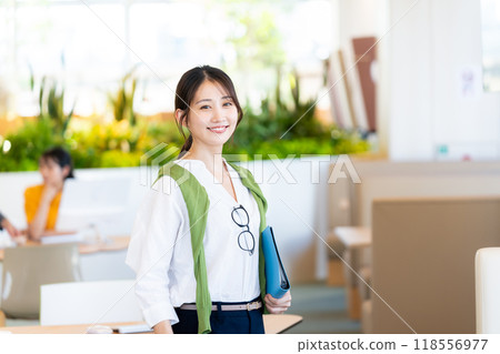 Businesswomen working in an office. Photo courtesy of Denpa Gakuen, Tokyo Electronics College. 118556977