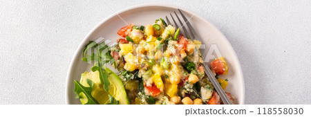 A vibrant vegetarian salad featuring boiled millet, chickpeas, fresh vegetables, and avocado, drizzled with olive oil for a delicious and healthy meal A vibrant vegetarian salad featuring boiled millet, chickpeas, fresh vegetables, and avocado, drizzled with olive oil for a delicious and healthy meal 118558030
