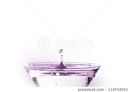 Close-up of water drop falling into a glass Close-up of water drop falling into a glass 118558052