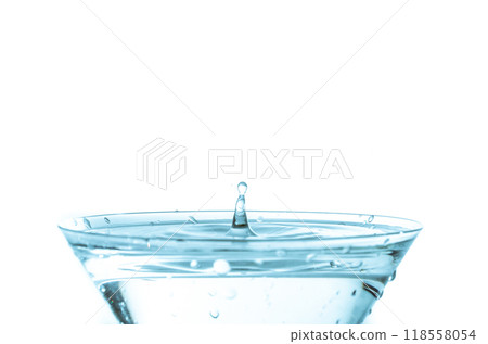 Close-up of water drop falling into a glass	 118558054