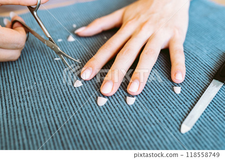 women's hands with manicure, one hand with trimmed nails women's hands with manicure, one hand with trimmed nails 118558749