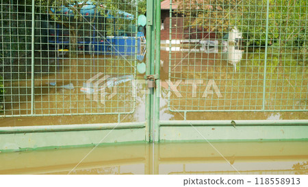 Flooded house garden fence lock river flood after water consequences damaged raging barrier wall rain threat houses building villages cars infrastructure surrounded destroyed raining Chomoutov Olomouc Flooded house garden fence lock river flood after water consequences damaged raging barrier wall rain threat houses building villages cars infrastructure surrounded destroyed raining Chomoutov Olomouc 118558913