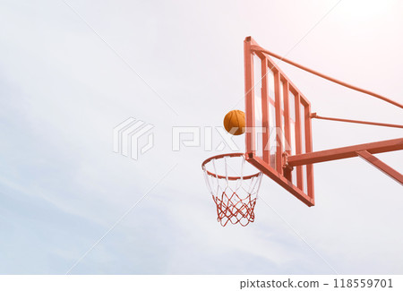 Basketball hoop with ball in mid-air against clear sky - perfect sports themes Basketball hoop with ball in mid-air against clear sky - perfect sports themes 118559701