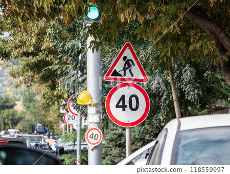 Road work traffic sign with a speed regulation signs in the city. High quality photo Road work traffic sign with a speed regulation signs in the city. High quality photo 118559997