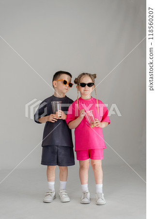 Little couple kids boy girl 4-5 years old clothes shirt dress posing have fun isolated on white background children studio portrait. People childhood lifestyle 118560207
