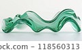 3d render of green glass wavy sculpture on white background 118560313