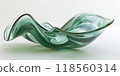 3d render of green glass abstract art in the shape of an elegant, wavy bowl with a smooth and glossy finish 118560314