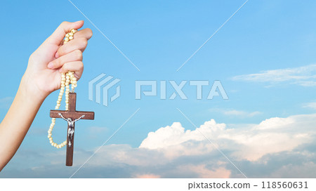 Brown wooden cross holding in hand, symbolizing, recalling and spreading of Jesus Christs love to all Christians Brown wooden cross holding in hand, symbolizing, recalling and spreading of Jesus Christs love to all Christians 118560631