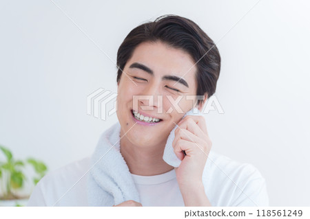 Man wiping sweat from his face 118561249