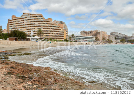 Stunning panoramic view of Calpe Spain with turquoise sea dramatic sky and beachfront hotels on a sunny summer day European vacation destination. Calpe Spain coastal landscape with rocky shore Stunning panoramic view of Calpe Spain with turquoise sea dramatic sky and beachfront hotels on a sunny summer day European vacation destination. Calpe Spain coastal landscape with rocky shore 118562032
