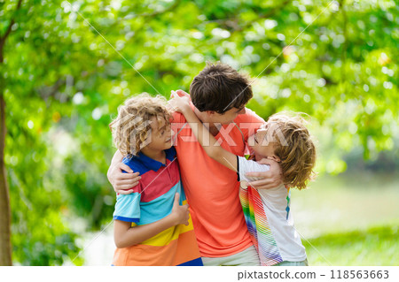 Brothers in summer park. Kids play outdoor. Brothers in summer park. Kids play outdoor. 118563663