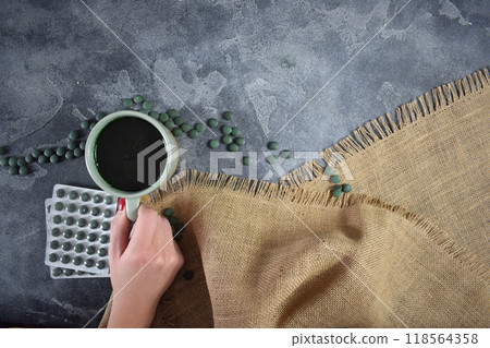 Green seaweed powder, pills and capsules. A cup of smoothie Green seaweed powder, pills and capsules. A cup of smoothie 118564358