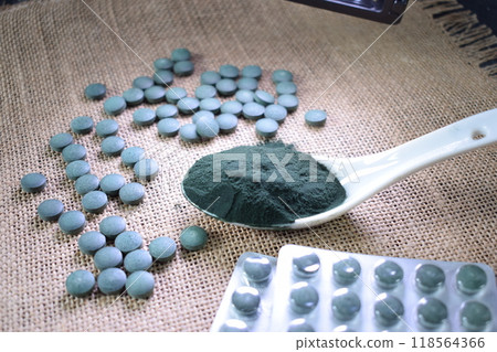A spoonful of green seaweed powder, pills and capsules 118564366