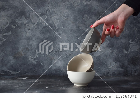 Three ceramic bowls isolated on gray background. 118564371