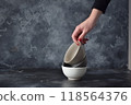Three ceramic bowls isolated on gray background. 118564376