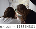 Two young girls photographing in a professional studio 118564381