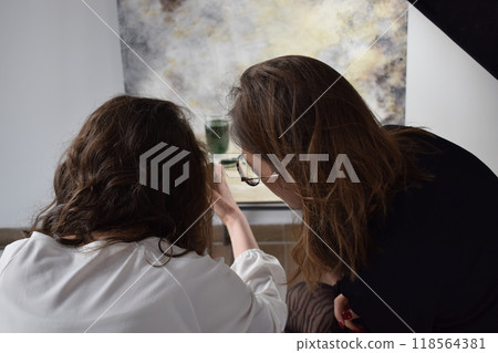 Two young girls photographing in a professional studio Two young girls photographing in a professional studio 118564381