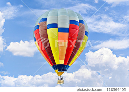 Colorful hot air balloon flying over blue sky with white clouds	 118564405