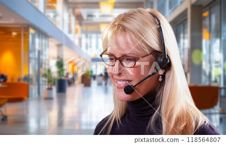Attractive Businesswoman Wearing Telephone Headset In An Office Setting. 118564807