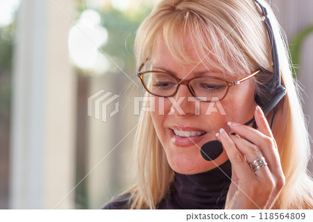 Attractive Businesswoman Wearing Telephone Headset In An Office Setting. 118564809
