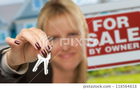 Female Real Estate Agent Presenting House Keys In Front of For Sale By Owner Sign & New House. Focus is on the Keys. Female Real Estate Agent Presenting House Keys In Front of For Sale By Owner Sign & New House. Focus is on the Keys. 118564818