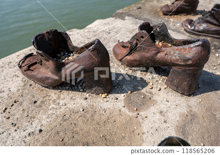 Budapest, Hungary. 25 August 2022. Memorial to the victims of the Nazi repression. Rusty metal copies of old shoes on the Danube River embankment. Holocaust and Nazi terror memory concept. 118565206