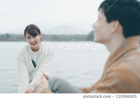 20 多歲的男性和女性在戶外微笑和交談 20 多歲的男性和女性在戶外微笑和交談 118566983