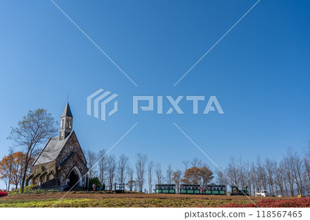 A church and a train seen beyond the flower fields of Hirugano Plateau Pastoral Village in autumn, Gujo City, Gifu Prefecture A church and a train seen beyond the flower fields of Hirugano Plateau Pastoral Village in autumn, Gujo City, Gifu Prefecture 118567465