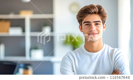 Confident young man smiling with folded arms in office Confident young man smiling with folded arms in office 118567648