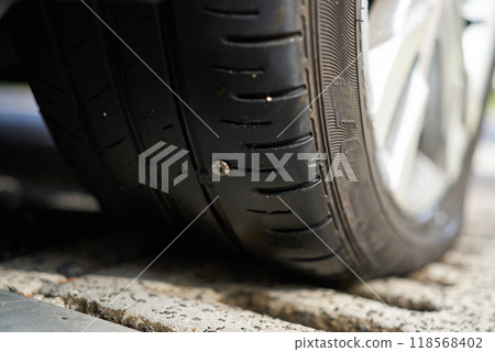 Car tire with nail in it Car tire with nail in it 118568402