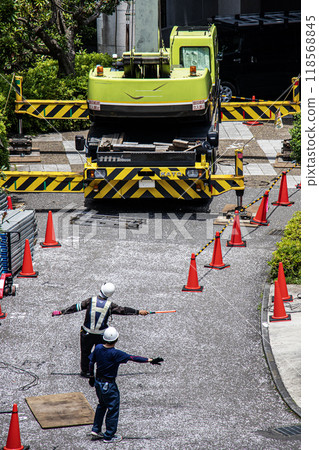 大型公寓大樓維修工地,起重機車將鷹架等臨時建築材料吊至高處。 大型公寓大樓維修工地,起重機車將鷹架等臨時建築材料吊至高處。 118568845