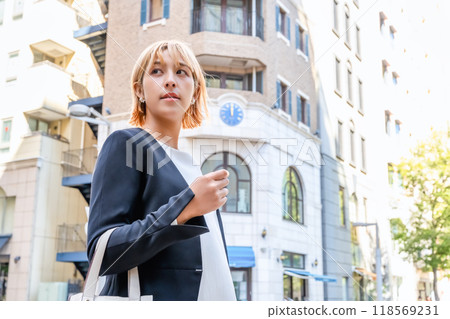 A blonde woman walking through Shinbashi's Italian district 118569231
